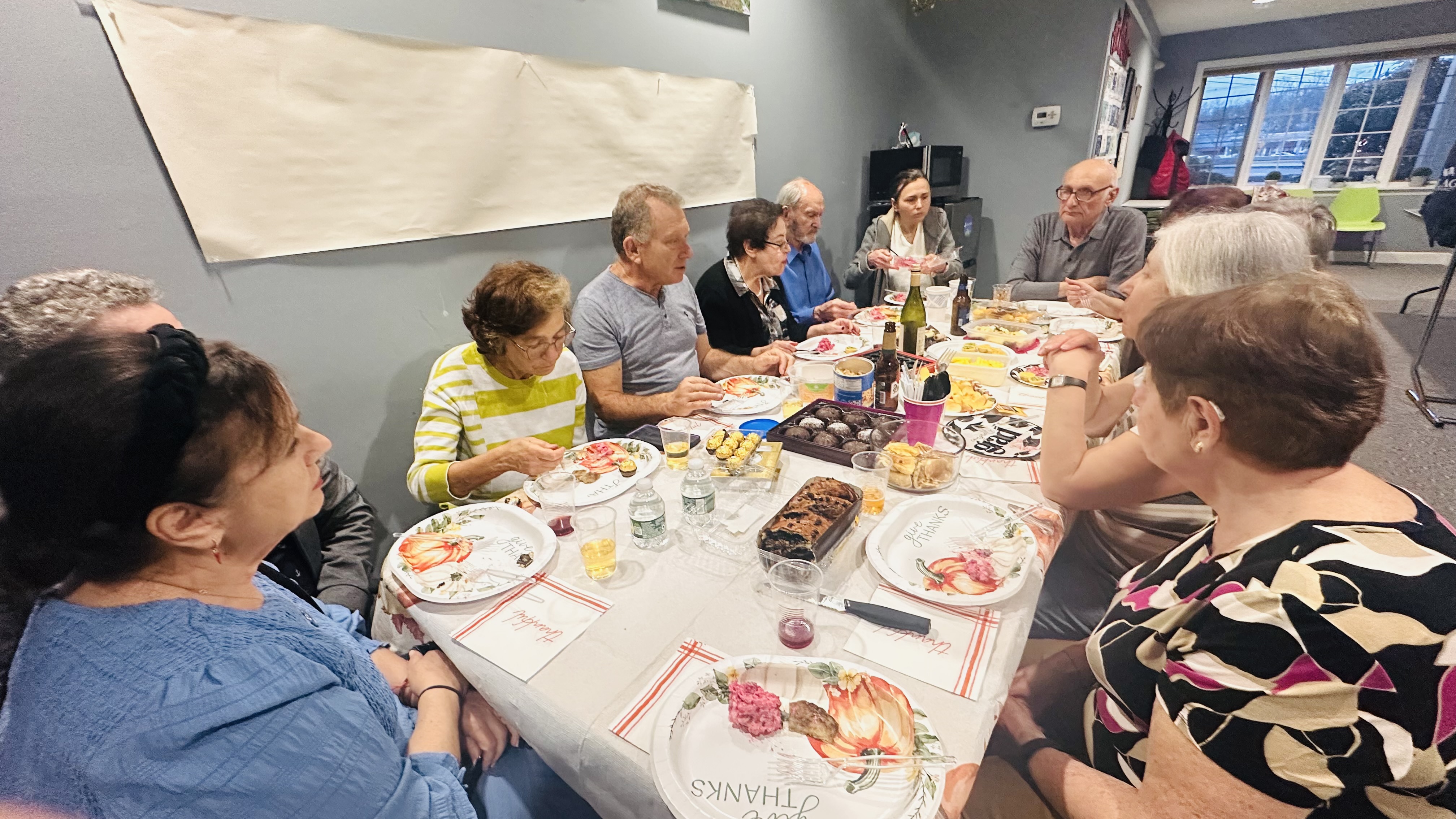 Participants seated around a table in conversation during the Jookender exhibition event