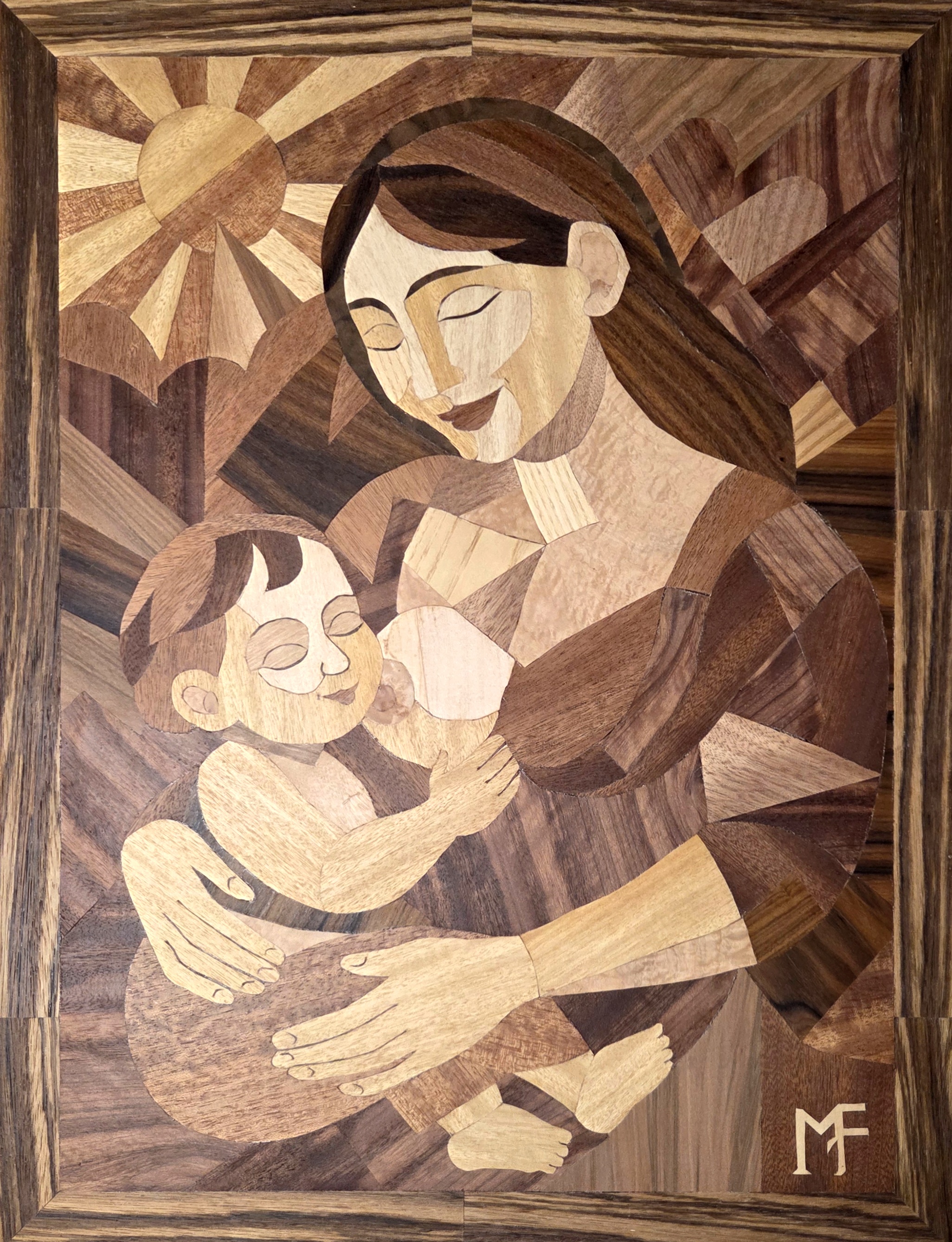 Panel — Madonna: marquetry wood-veneer composition of a mother holding and nursing her child beneath a radiant sun